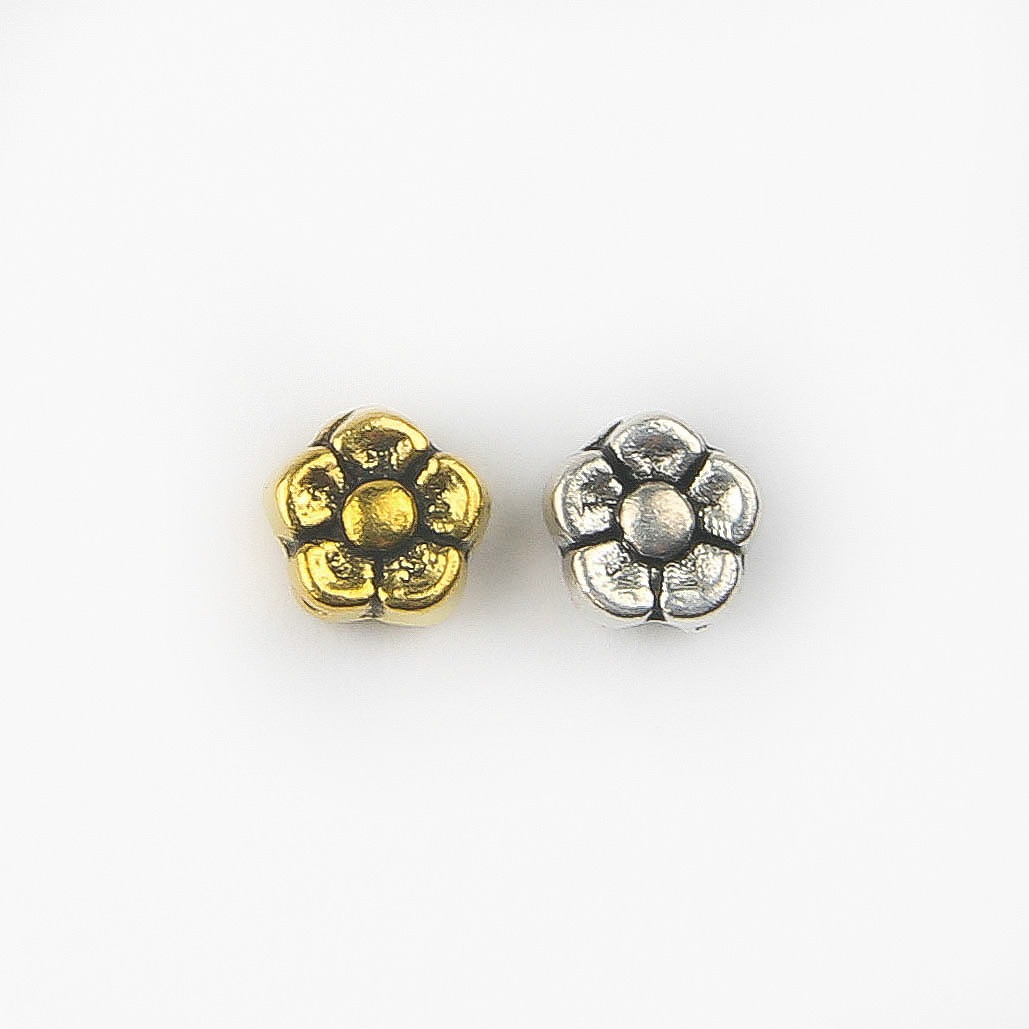 Gold and silver flower spacer beads with raised petal detail for jewellery making and craft projects