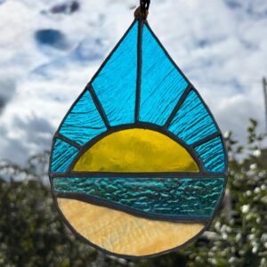 Handmade stained glass beach sunrise light catcher created using the Tiffany copper foiling method