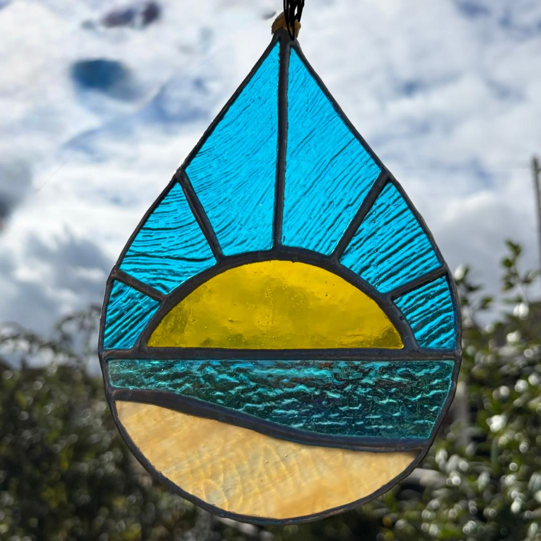 Handmade stained glass beach sunrise light catcher created using the Tiffany copper foiling method