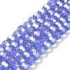 8mm faceted crystal round bead in a vibrant transparent blue colour with white shimmers from the light.