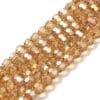 8mm faceted crystal round bead in a vibrant transparent gold colour with white shimmers from the light.