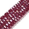 8mm faceted crystal round bead in a mysterious transparent red colour with white shimmers from the light.