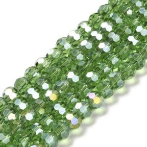 8mm faceted crystal round bead in a vibrant transparent green colour with white shimmers from the light.