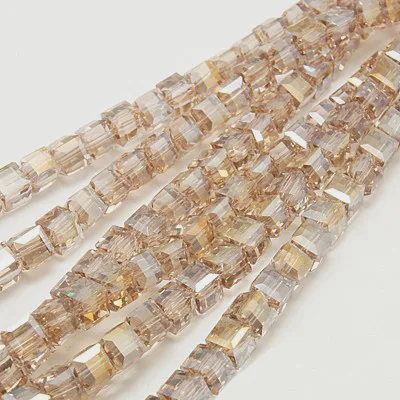 Strand of 4mm Glass Cube's in sand AB, the aurora borealis finish gives them a rainbow like shimmer in the light.
