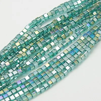 Strand of 4mm Glass Cubes in Green AB, the aurora borealis finish gives them a rainbow like shimmer in the light.