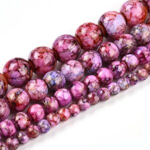 Marbled Glass Beads - Magenta Bloom. The beads come in 4 sizes as shown in the picture and are a mixture of purple and pink with golden streaks throughout.