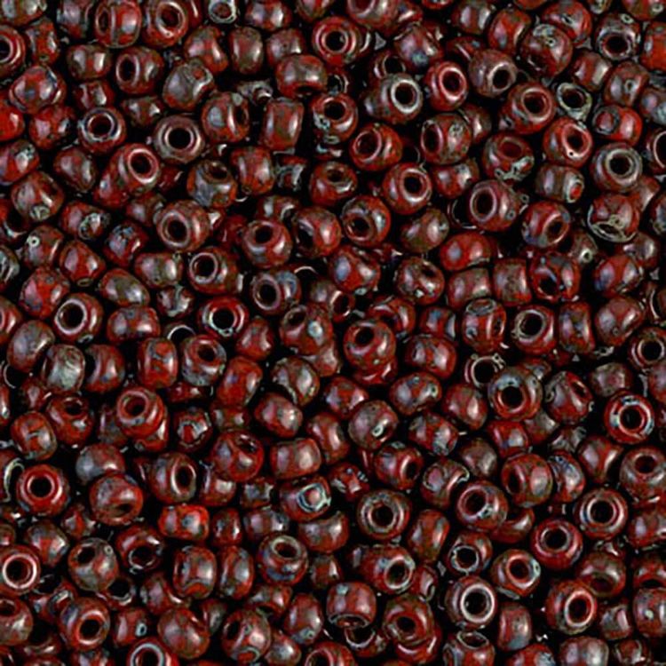 Detailed view of matte glass seed beads in Picasso Opaque Red Garnet shade.