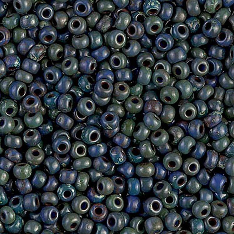 Detailed view of Miyuki matte glass seed beads in Montana blue with Picasso glaze.