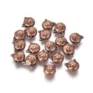 Copper: Antique copper cat head spacer beads with engraved whiskers, ears and smiling facial detail.