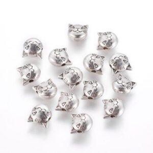 Antique silver: Antique silver cat head spacer beads with engraved whiskers, ears and playful facial detail.