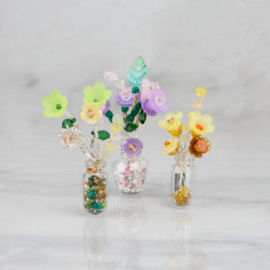 Beaded Forever Flowers Kit by Riverside Beads featuring a floral bouquet in a miniature vase, floral brooch and bonus button bracelet project.