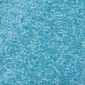 Close-up of Miyuki Delica DB057 Lined Sky Blue AB seed beads with a soft blue shimmer.