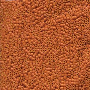 Close-up of Miyuki Delica DB653 Opaque Pumpkin seed beads in a warm orange shade