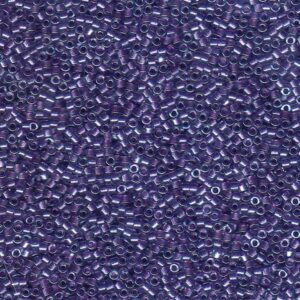 Close-up of Miyuki Delica DB906 Sparkling Purple Lined Crystal seed beads with a shimmering purple finish
