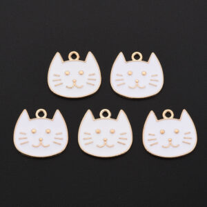 White enamel cat head charms with gold-tone outlines, facial details and top loops for jewellery making.