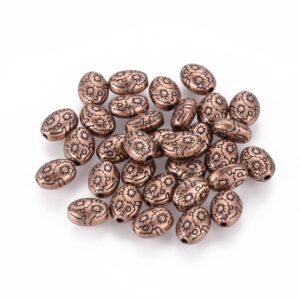 Copper: Antique copper oval spacer beads with embossed flowers and darkened detail for a rustic look.
