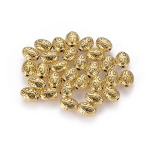 Antique gold: Antique gold oval spacer beads with a raised floral design and vintage-style finish.