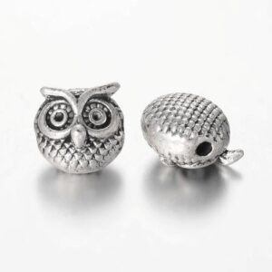 Antique silver: Antique silver owl spacer beads with large eyes, feather texture and a side threading hole.