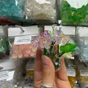 People creating colourful beaded flowers for a miniature everlasting bouquet during Beaded Bloom Club at Riverside Beads & Crafts.