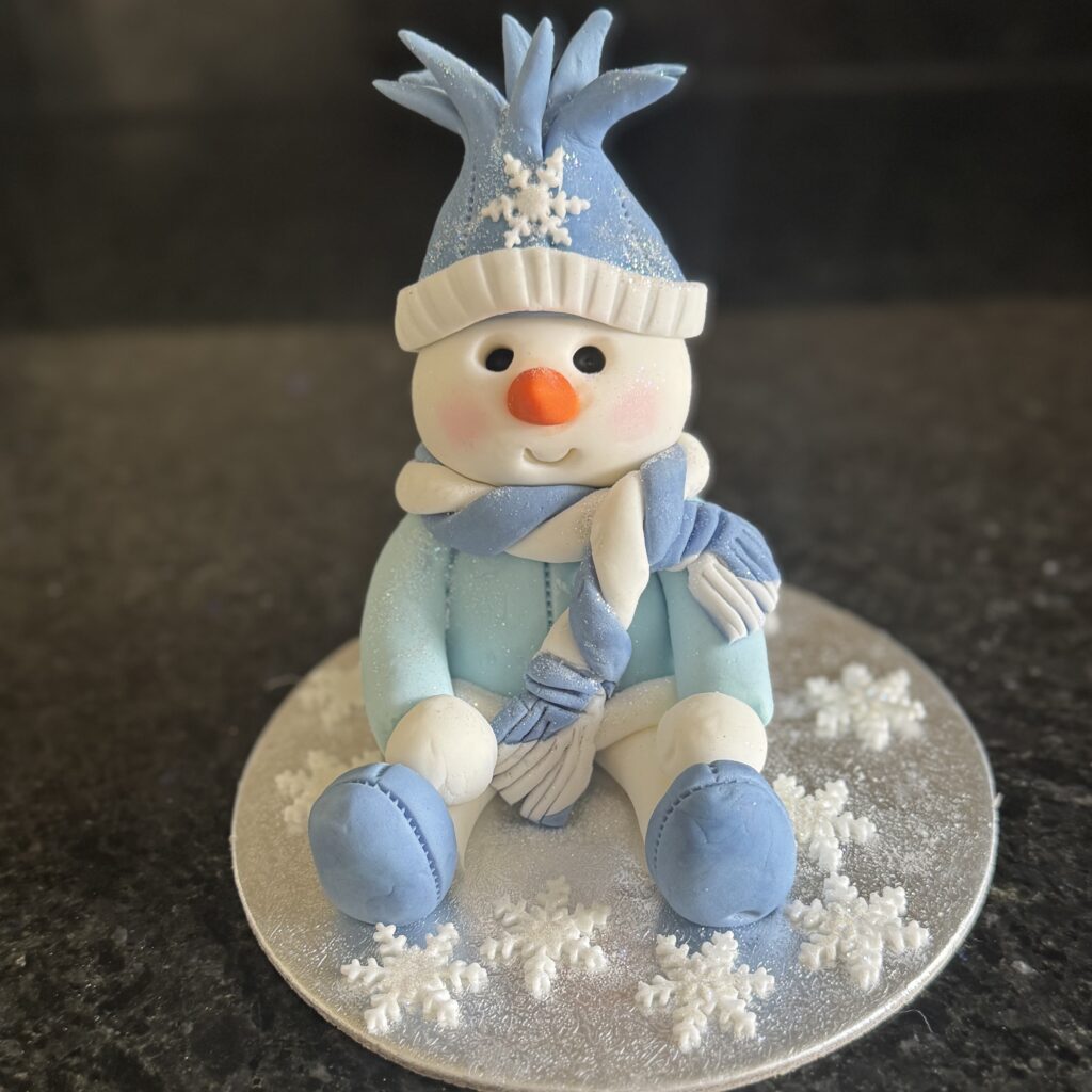 Handmade snowman Christmas cake topper created in sugarcraft workshop at Riverside Beads & Crafts
