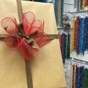 Beautifully wrapped gifts in natural kraft paper with decorative ribbons, bows and trims